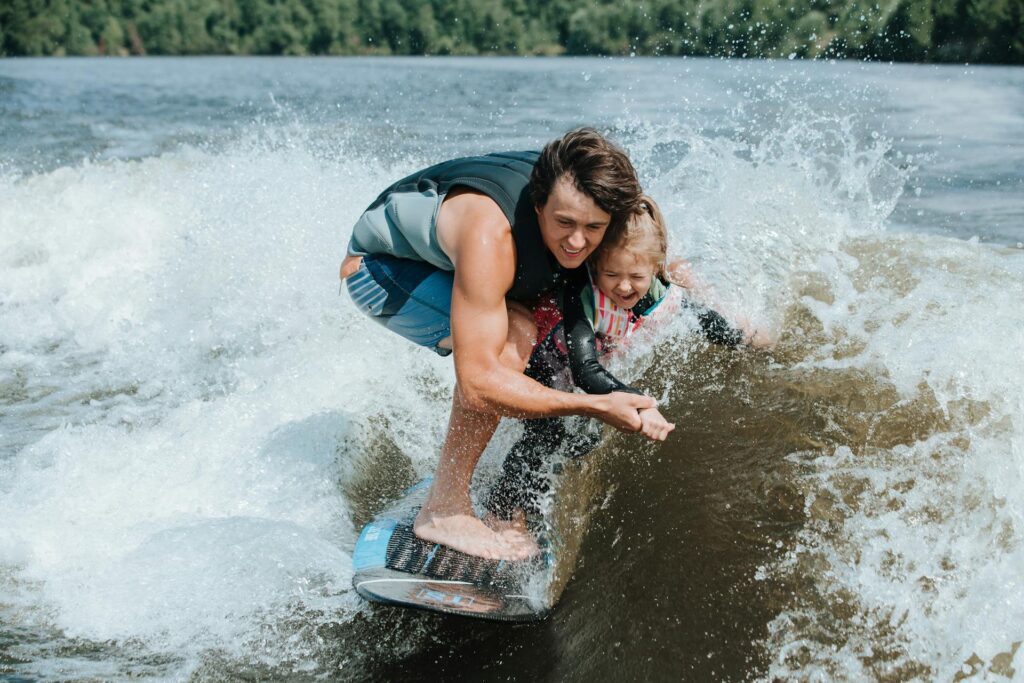A father and daughter wakeboarding