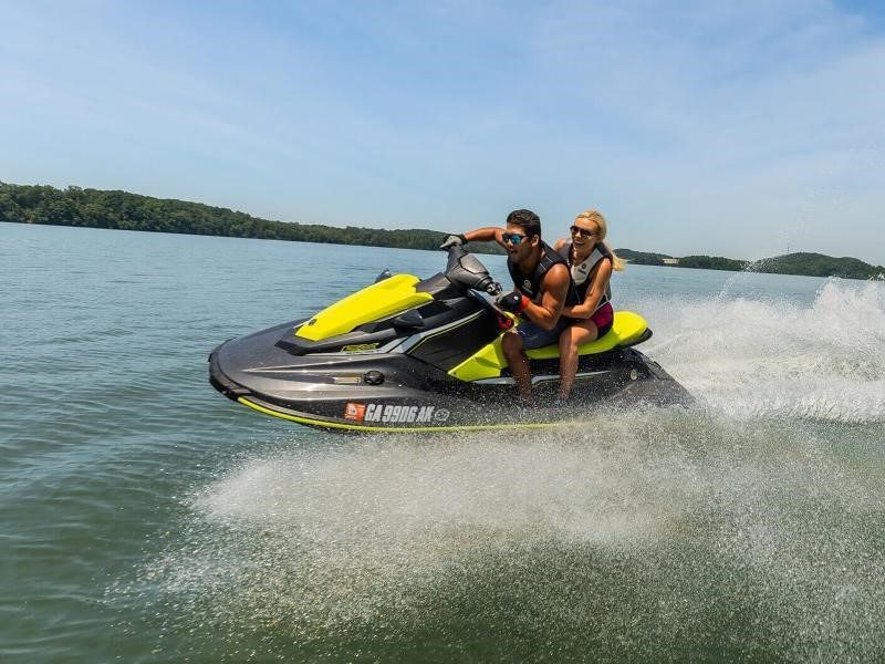 A couple riding a jet ski.